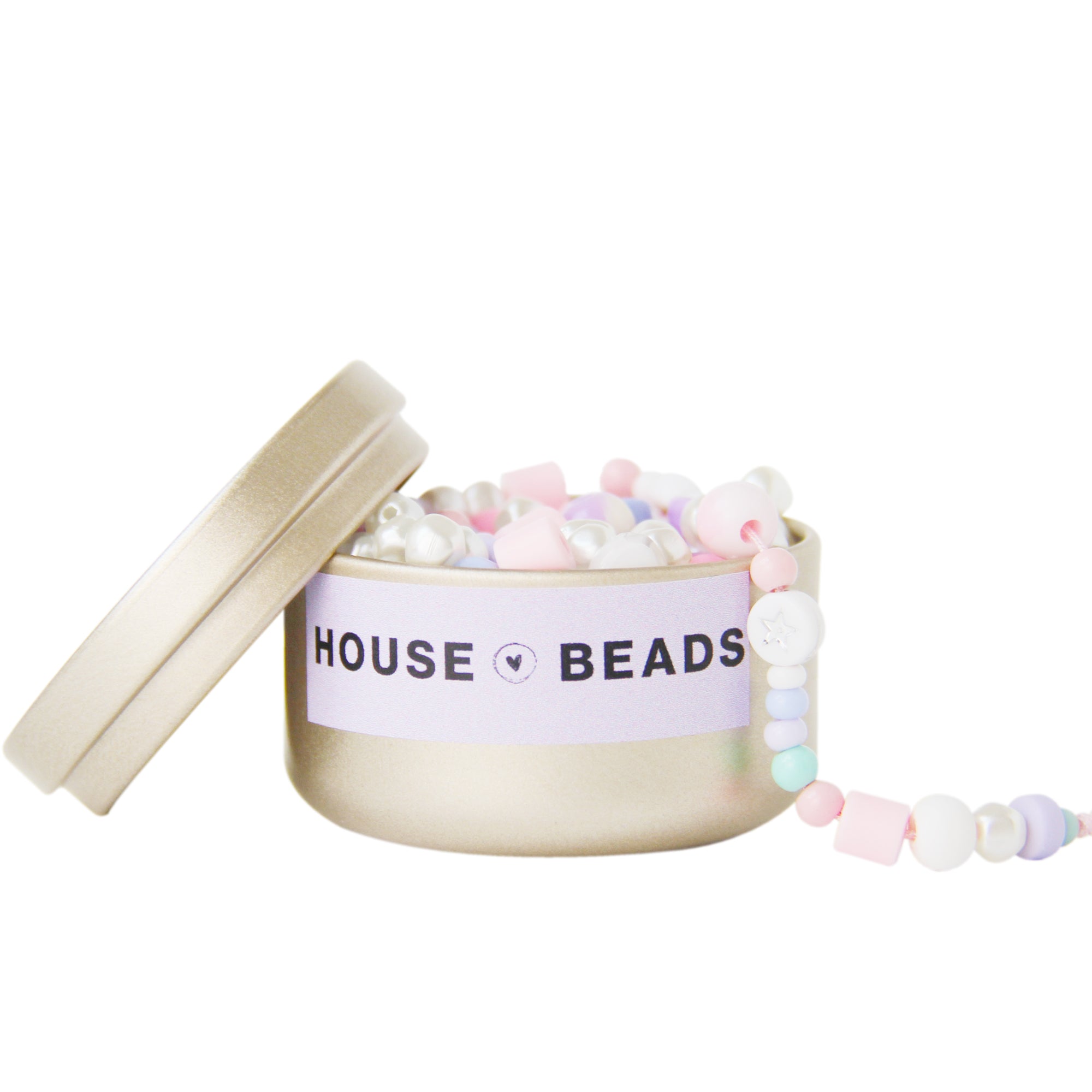 Gold 'House of Beads' tin containing a mix of pastel beads on a white background