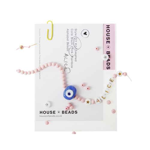 House of Beads friendship bracelet kit with pink beabds, an evil eye bead and alphabet beads on a white background